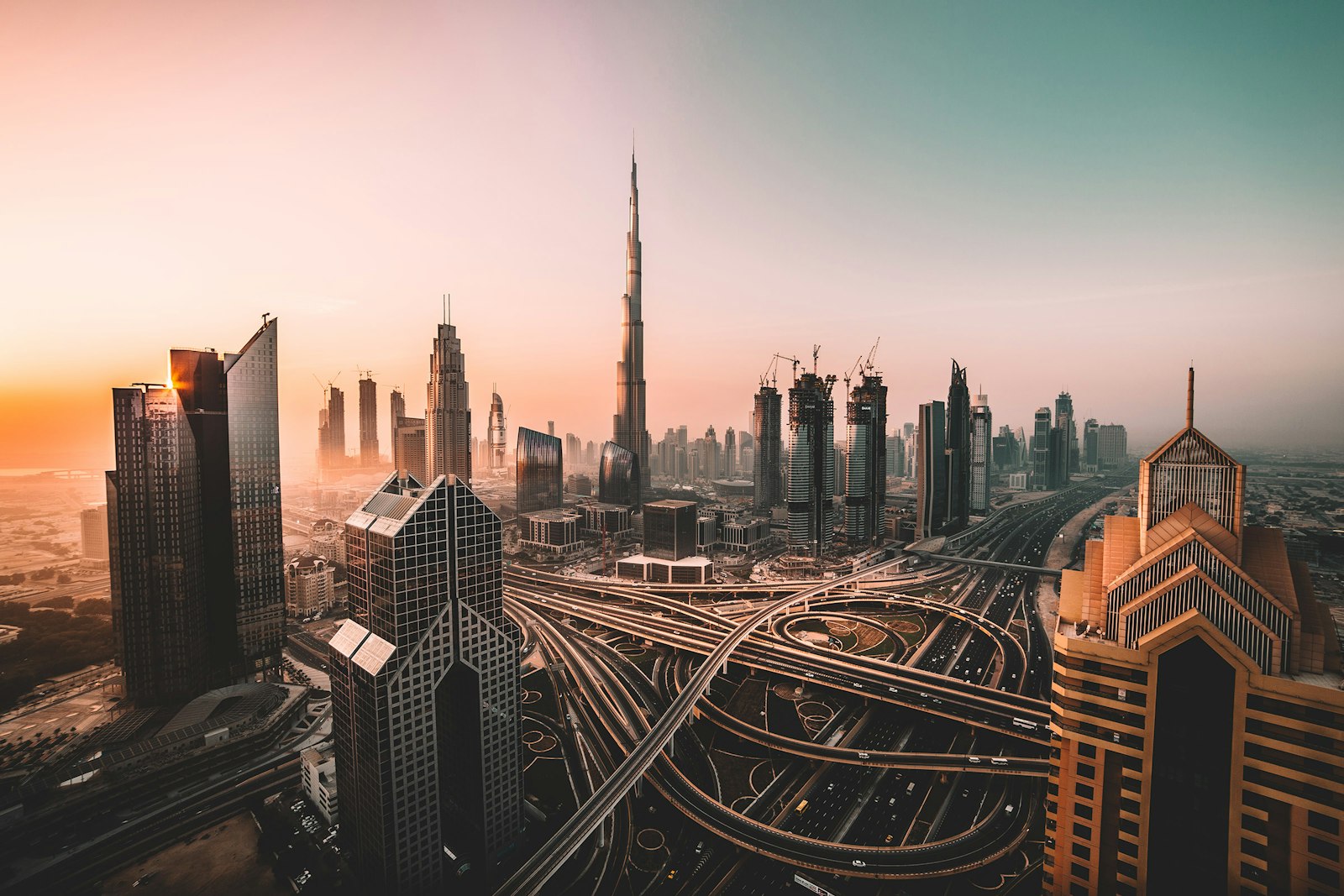 Gulf skyline at sunrise with towers under construction